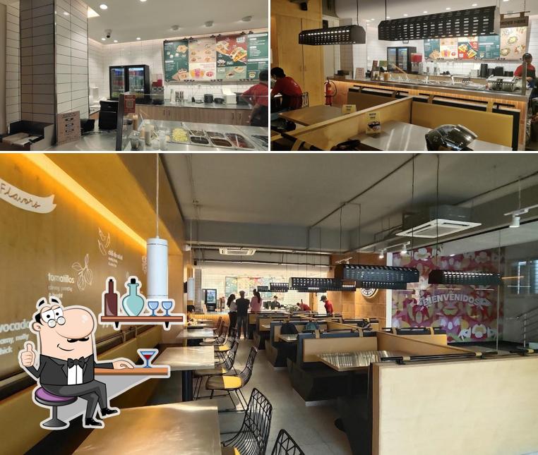 Take a seat at one of the tables at California Burrito Mexican Kitchen @ Kanakpura