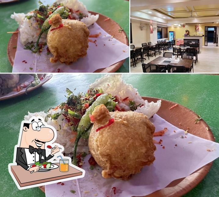 The photo of Hotel Sai Sharada’s food and interior