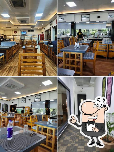 Take a seat at one of the tables at খাৰখোৱা ৰিজর্ট ,NH 15 আউলাচৌকা
