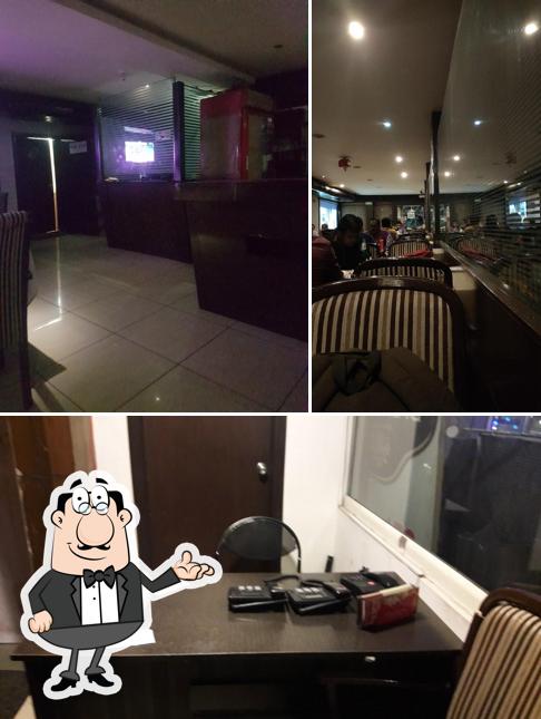 Take a seat at one of the tables at Big Spice Bar And Restaurant