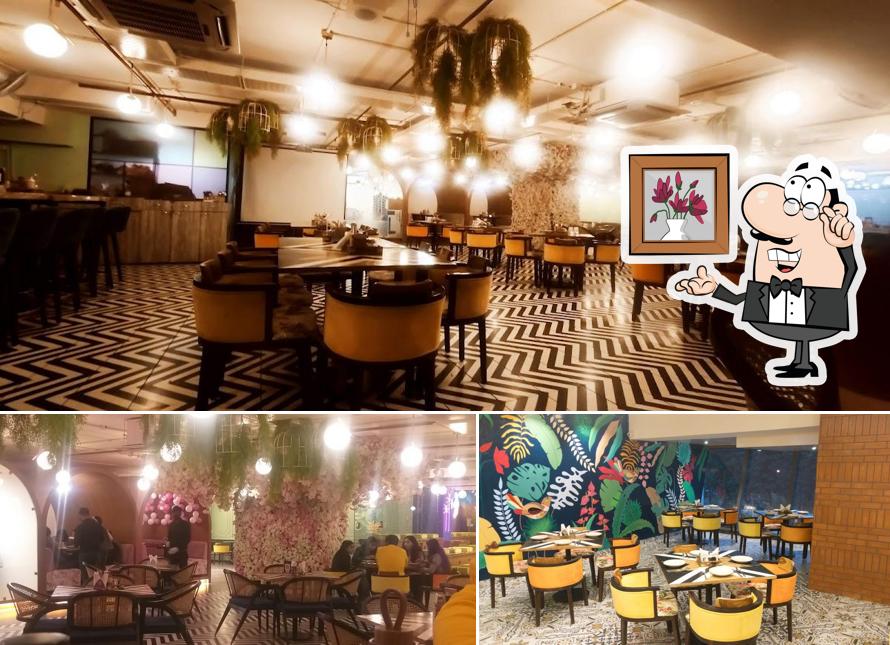 Take a seat at one of the tables at Cafe Split Bean - Pure Veg. Cafe & Restaurant Party Place