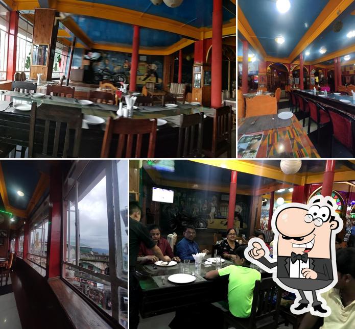 Take a seat at one of the tables at King Thai Hotel And Restaurant (SUPER MARKET)