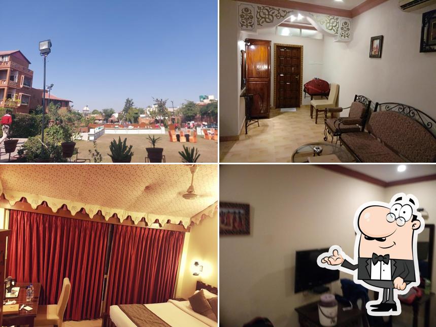 Take a seat at one of the tables at Hotel Nirali Dhani