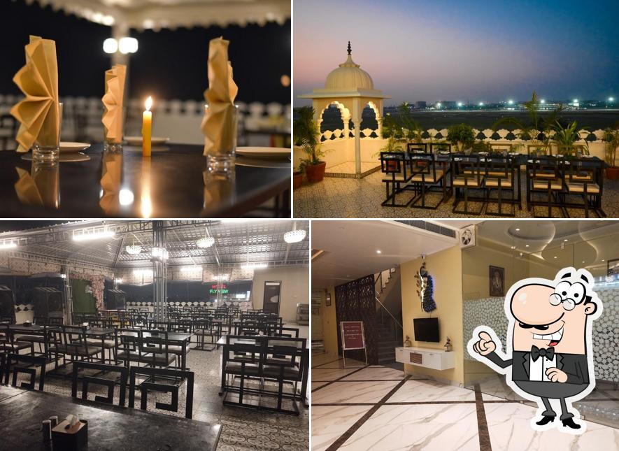 Take a seat at one of the tables at Hawai Chhatri Roof Top Restaurant