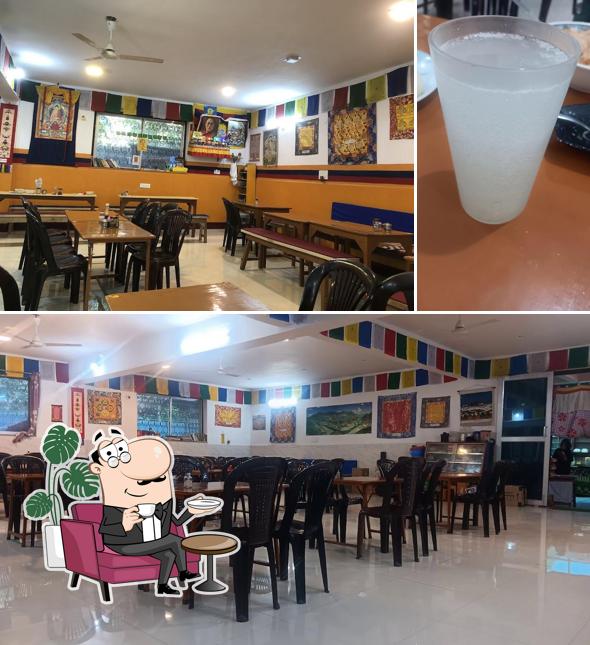 Take a look at the photo displaying interior and beverage at Tibet Om Cafe (Vegetarian and vegan)