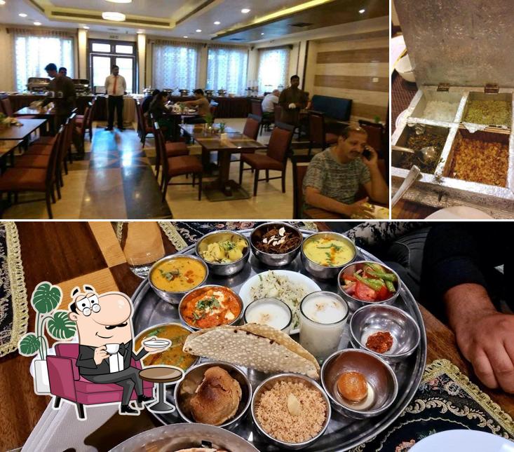 Take a seat at one of the tables at Navidya By Amantra Hotels