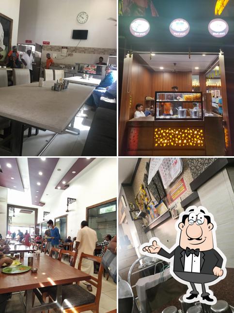 Take a seat at one of the tables at Aryaas Park Veg Restaurant