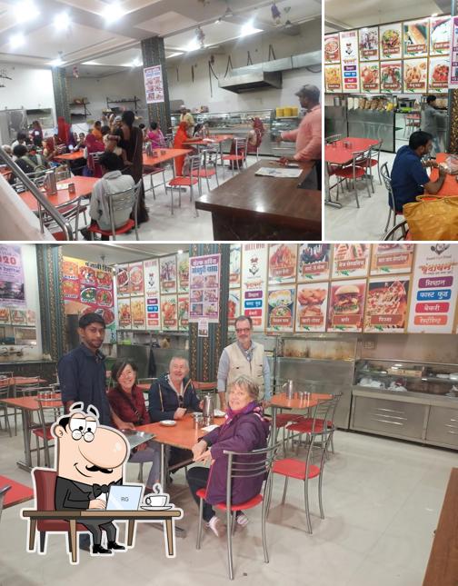 Take a seat at one of the tables at Vrindavan resturant & sweets