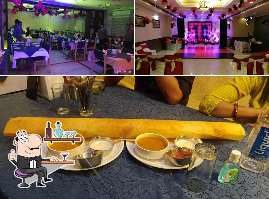 Take a seat at one of the tables at Hotel Inderlok Classic (A Unit Of Inderlok Hospitality Pvt Ltd)