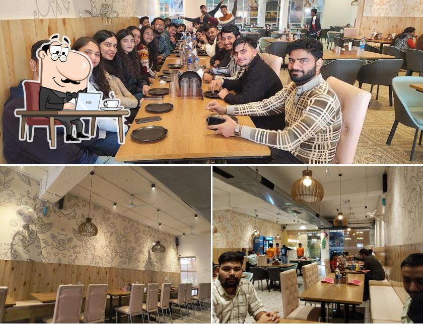 Take a seat at one of the tables at Royal Dhaba Family Restaurant Gurgaon