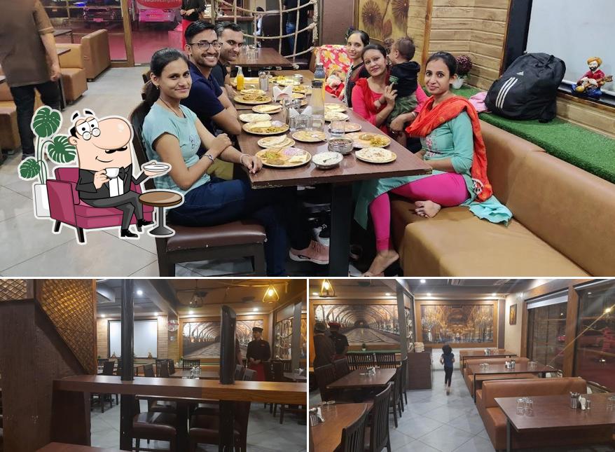 Take a seat at one of the tables at Shree Marutinandan kathiawadi & garden restaurant