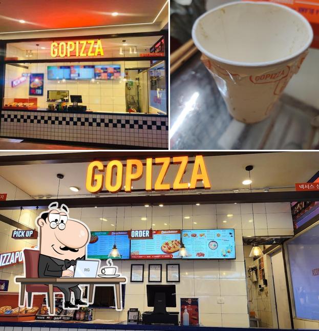 Take a seat at one of the tables at GOPIZZA Nexus Shantiniketan
