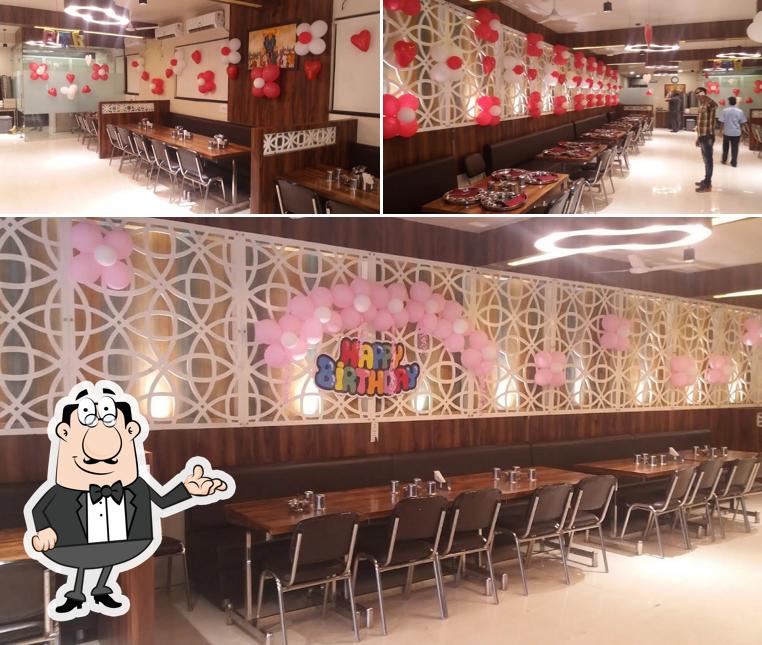 Take a seat at one of the tables at Prem Thali Restaurant & Lawns