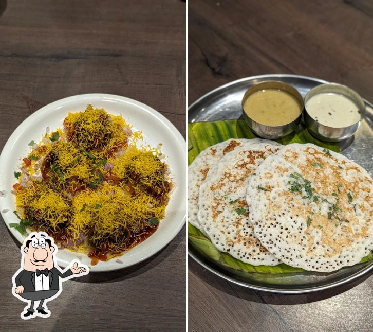 Take a seat at one of the tables at Navmi Veg Resto