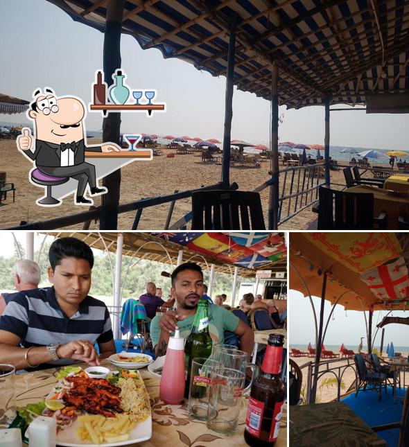 Take a seat at one of the tables at Sam's Beach Shack GOA