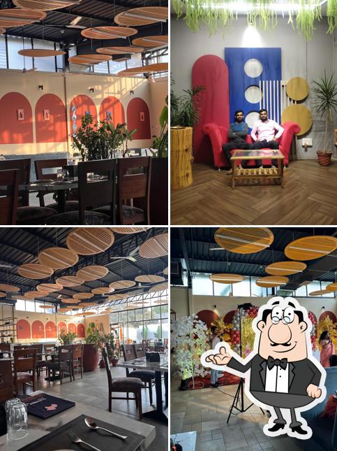 Take a seat at one of the tables at Pahunchar Pure Veg Restaurant