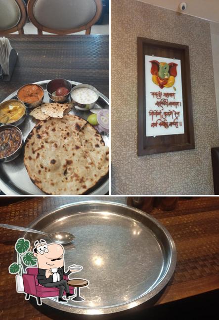 Take a seat at one of the tables at Bhagat Tarachand Pure Veg. Restaurant