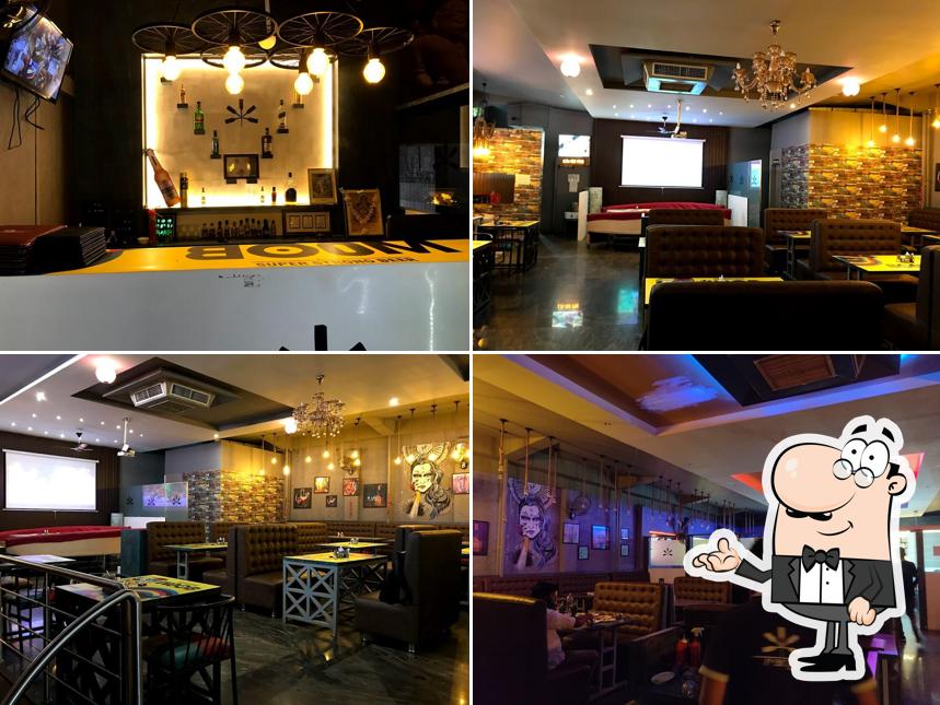 Take a seat at one of the tables at Rangoon Veg - Non veg Resto Bar