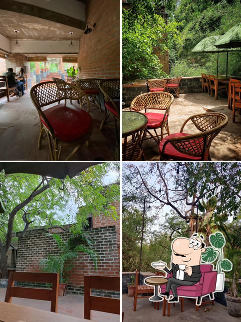 Take a seat at one of the tables at Aarambh Cafe