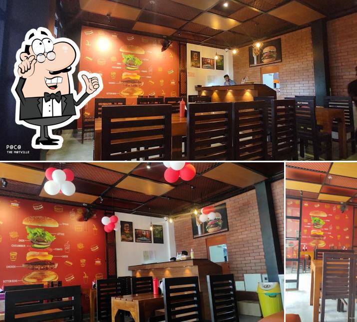Take a seat at one of the tables at Burger lounge Sulthan bathery Take a seat at one of the tables at Burger lounge Sulthan bathery