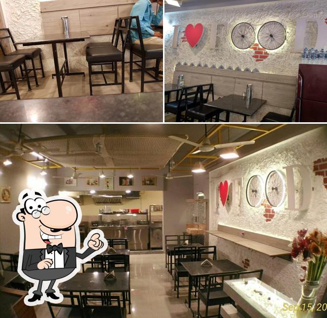Take a seat at one of the tables at HOTTE THUMBA PURE VEG RESTAURANT
