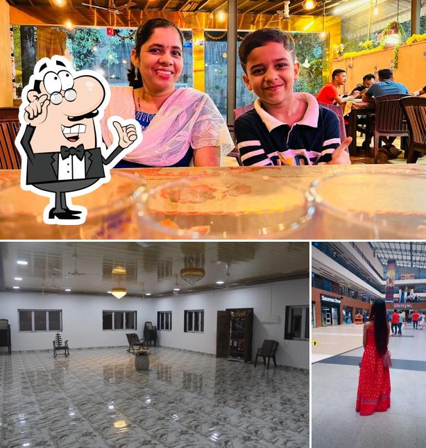 Take a seat at one of the tables at Hotel zee garden family restaurant and bar