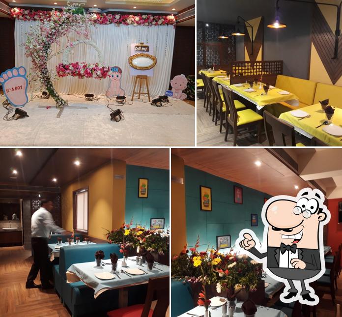 Take a seat at one of the tables at Hotel Chandrahas Family Deluxe