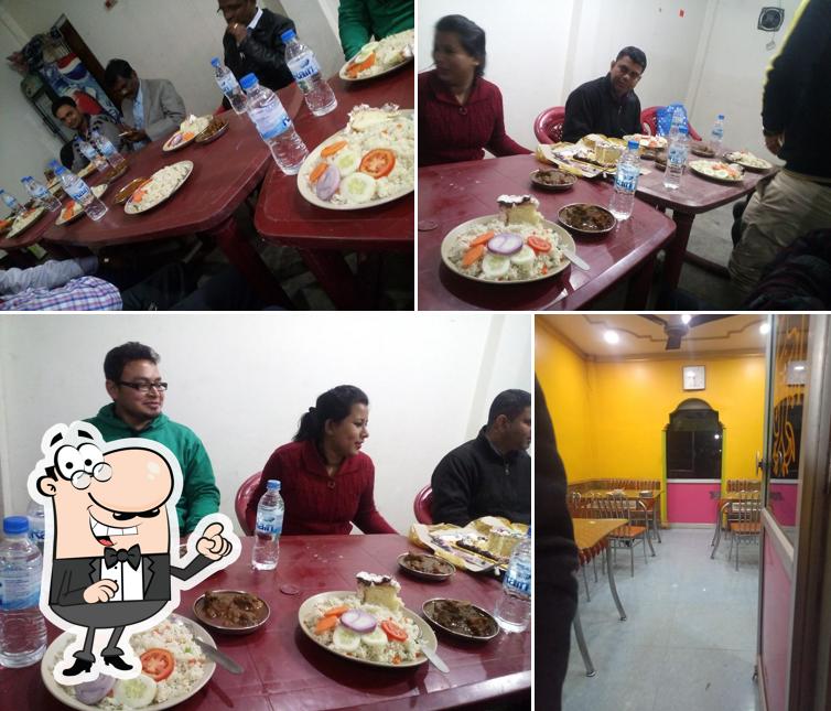 This is the photo showing interior and dining table at Khana Khajana Restaurant