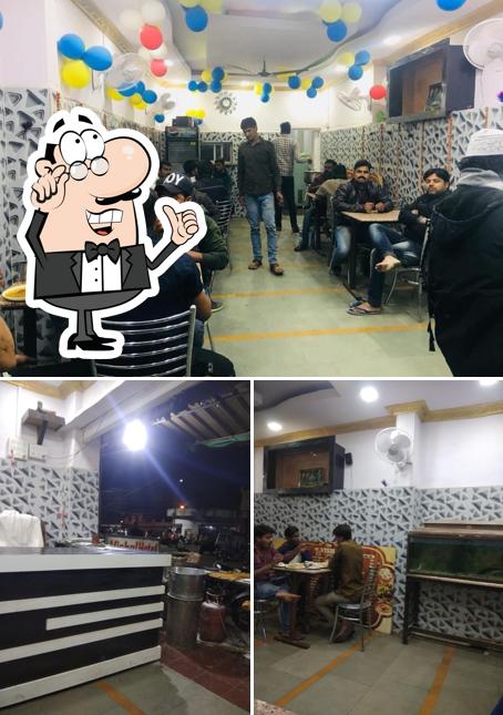 Take a seat at one of the tables at Vishal Hotel