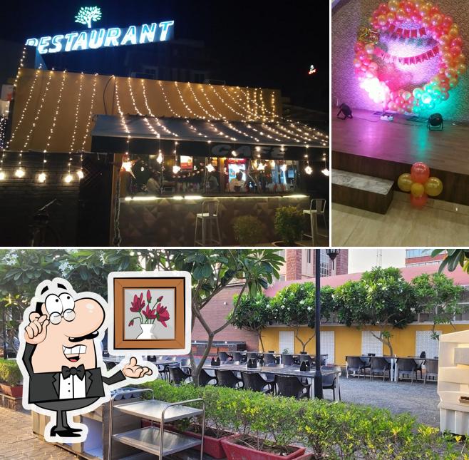 Take a seat at one of the tables at Kalpvriksha Restaurant