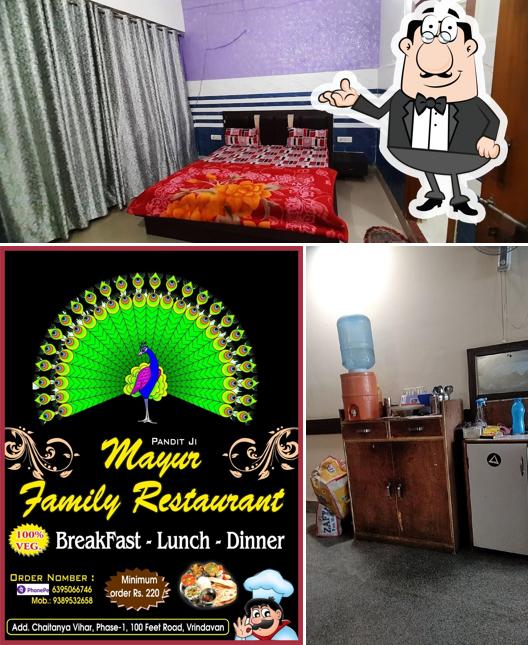 Take a seat at one of the tables at Mayur Rooms & Family Restaurant