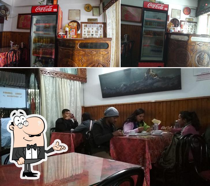 Take a seat at one of the tables at China Garden Restaurent and Lodge