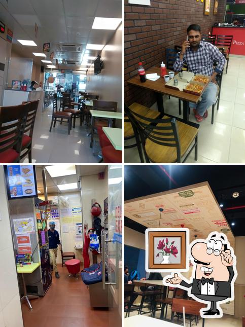 Take a seat at one of the tables at Domino's Pizza M.G. Mall, Sonipat