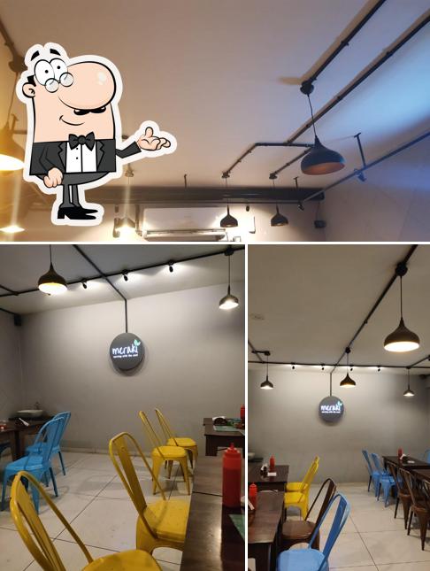 Take a seat at one of the tables at Meraki Cafe - Danny’s Coffee Bar