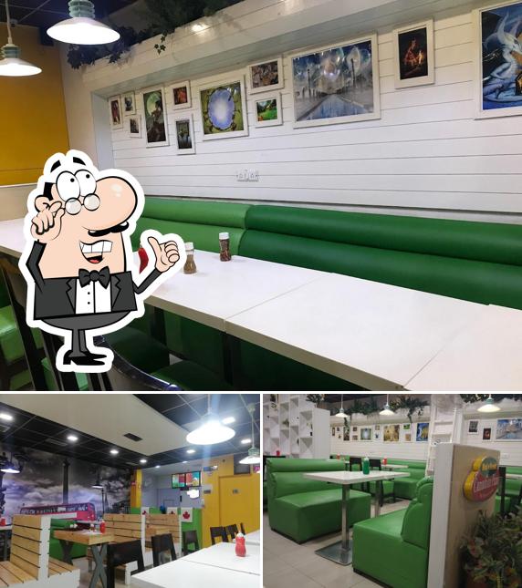 Take a seat at one of the tables at Canadian Pizza Patiala Omaxe Mall