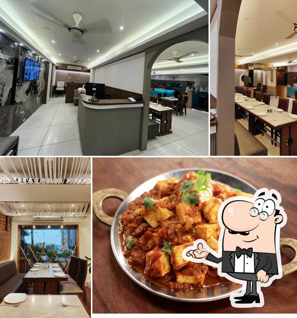 Take a seat at one of the tables at Tandoor Palace Hotel & Restaurant