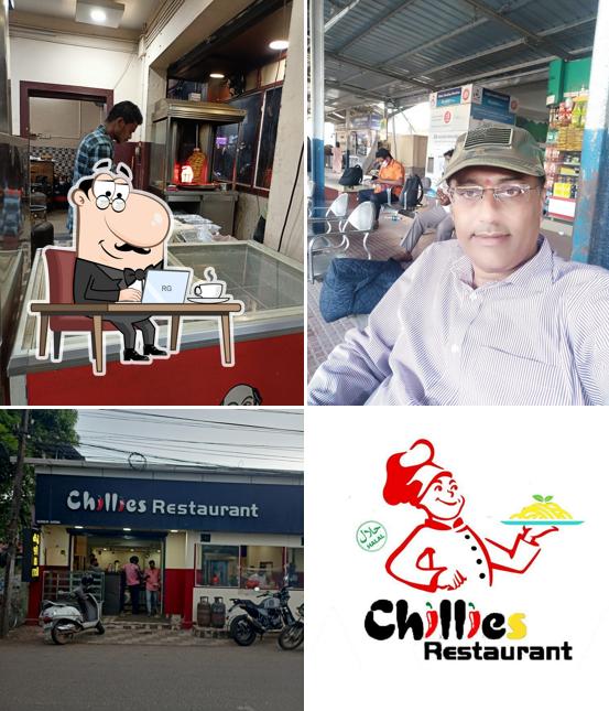 Take a seat at one of the tables at Chillies Restaurant Alappuzha
