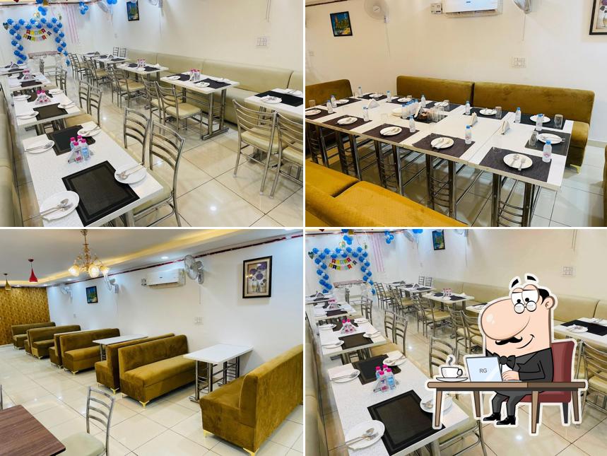 Take a seat at one of the tables at FATEH SWEETS BAKERY & FASTFOOD