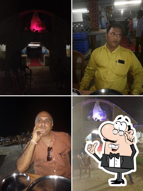 Take a seat at one of the tables at Sai Madhuli Restaurant