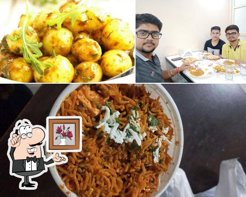 Take a seat at one of the tables at Vaishnu Hotel