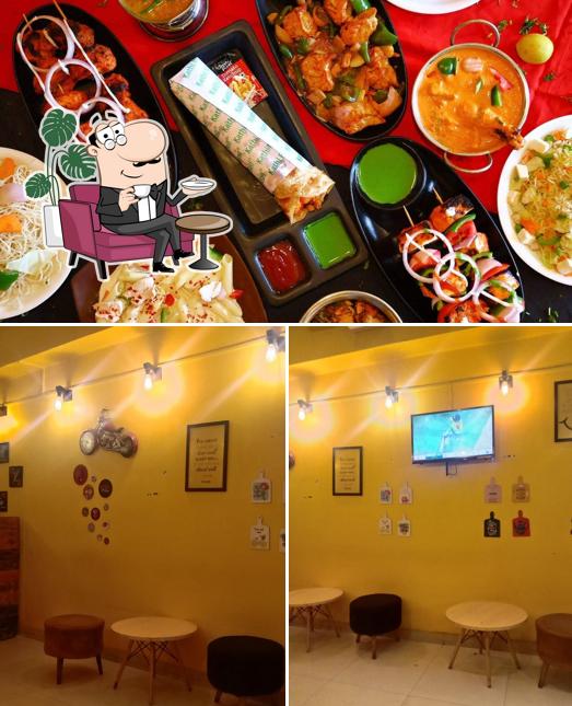 Take a look at the image displaying interior and food at Kathi junction