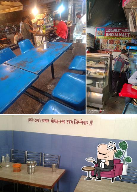 Take a seat at one of the tables at Jagdambay Vaishno Bhojanalay