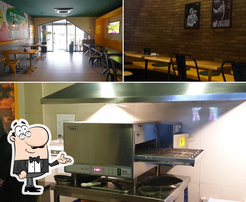 Take a seat at one of the tables at Oyalo pizza Reddiarpalayam