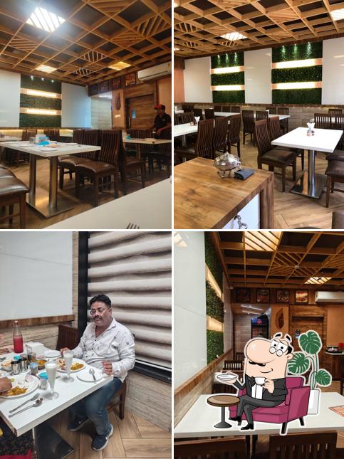 Take a seat at one of the tables at New Shree Ram Dairy Restaurant