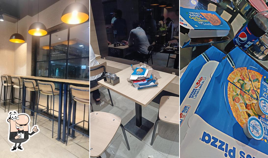 Take a seat at one of the tables at Domino's Pizza