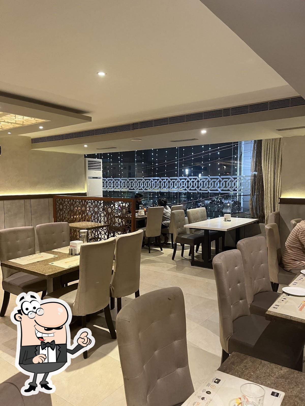 Take a seat at one of the tables at Palmshore Restaurant Medavakkam.