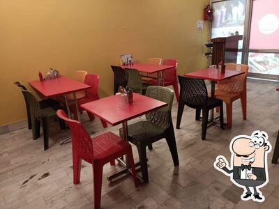Take a seat at one of the tables at Chings Fast Food & Restaurant