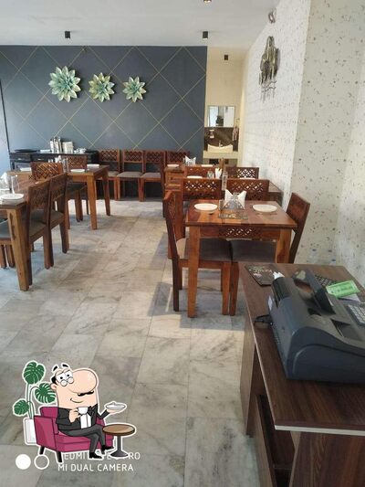 Take a seat at one of the tables at Kesar Restaurant
