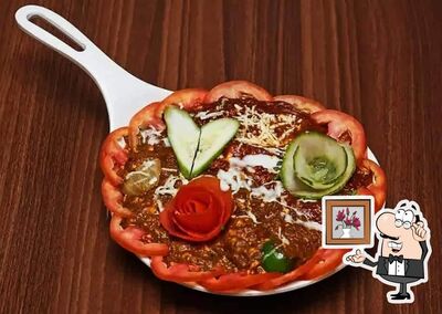 Take a seat at one of the tables at Bhoomika Restaurant