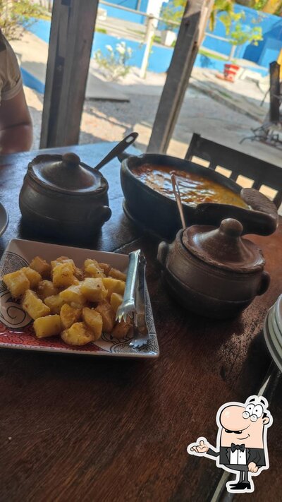 Sente em uma das mesas no Bar e Restaurante Cajueiro